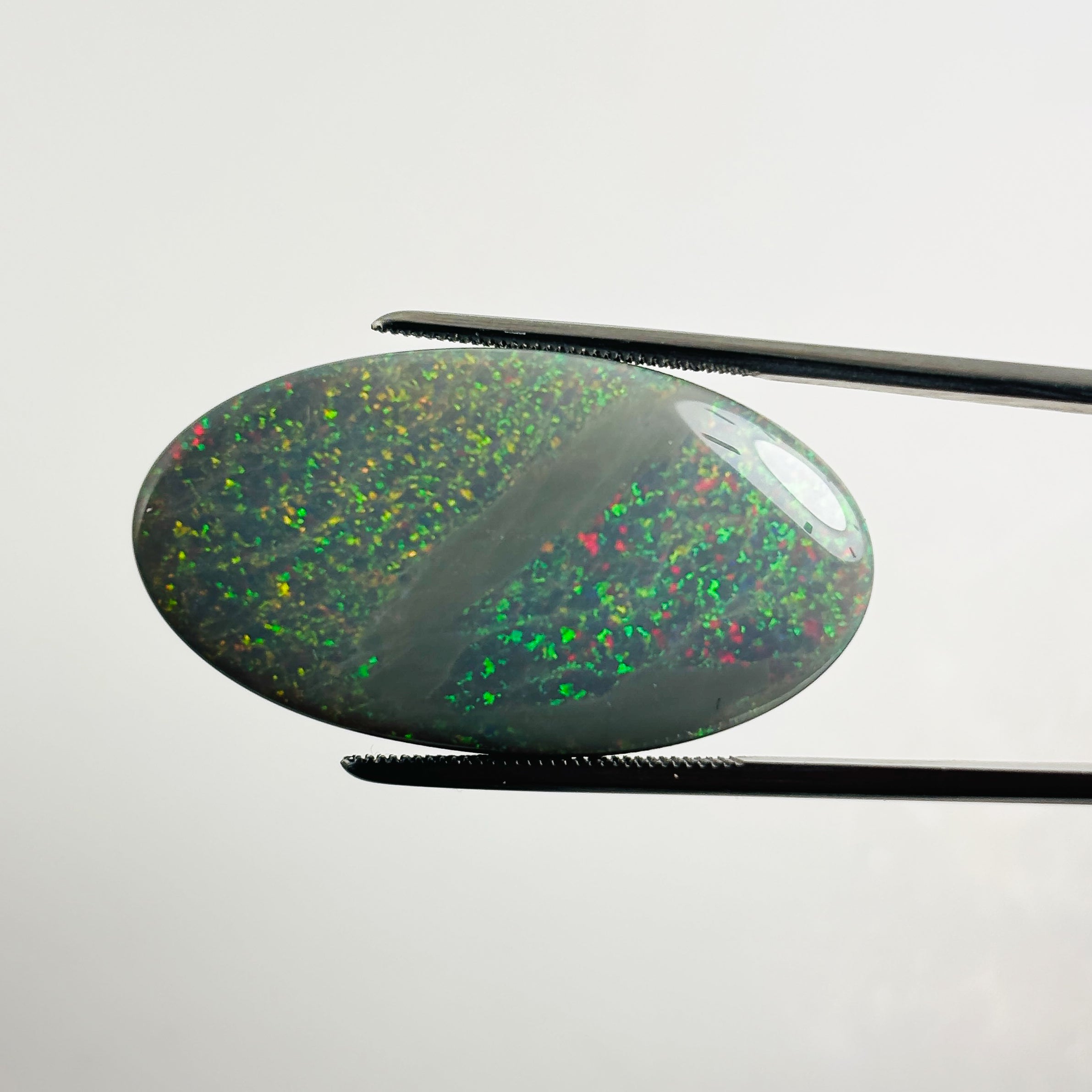 Semi Black Opal Red Multicolour 33x18x6.8 Cabochon Oval 27.25 Carat