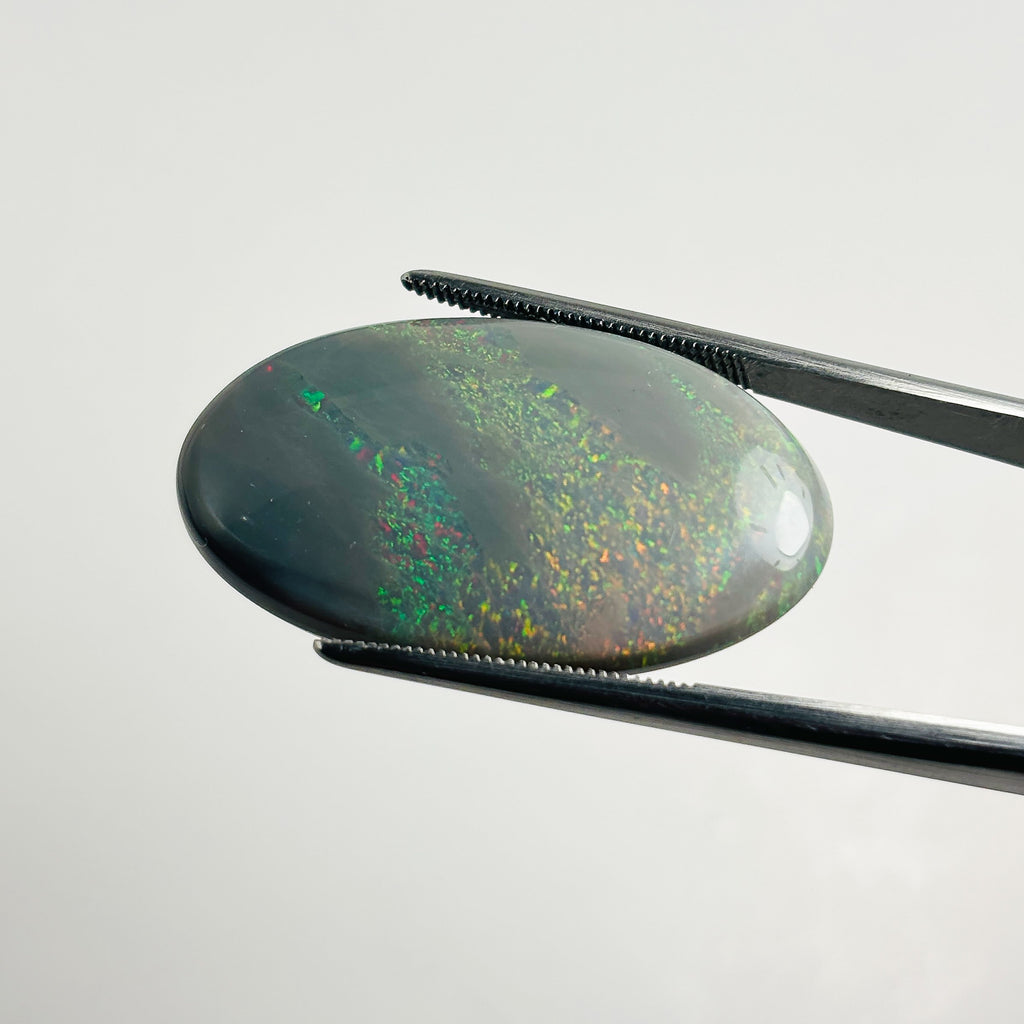 Semi Black Opal Red Multicolour 33x18x6.8 Cabochon Oval 27.25 Carat